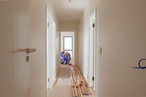a couple of men working on a house